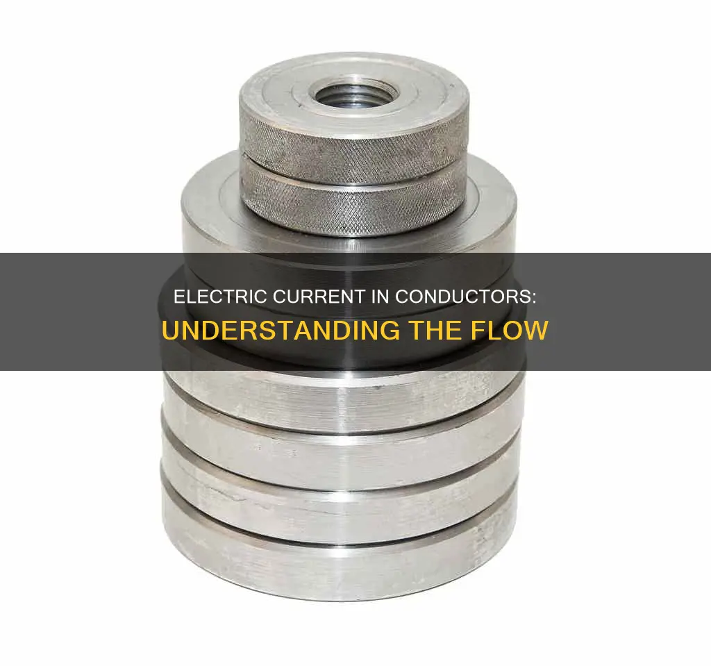 what constitutes the electric current in a metallic conductor
